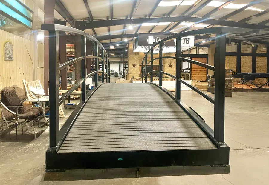 Factory assembly of a low-profile arched pedestrian/cart bridge.